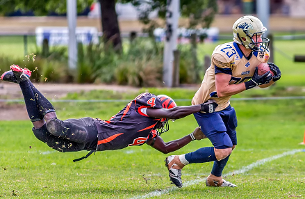 Handstand push-up performance supplements football player trying to tackle another player