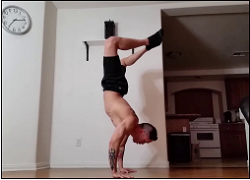 handstandpushup.com handstand push-up home workouts 90 degree handstand push-up bent knees side view black shorts