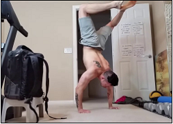 handstandpushup.com handstand push-up home workouts 90 degree handstand push-up knees together variation grey shorts