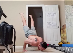 handstandpushup.com handstand push-up home workouts 90 degree handstand push-up with side to side plyo push-ups combination grey shorts